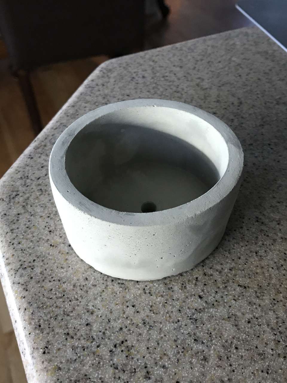 Small concrete planter with drainage hole