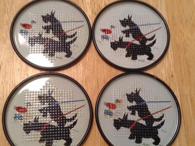 4 VINTAGE SCOTTISH TERRIER METAL COASTERS.