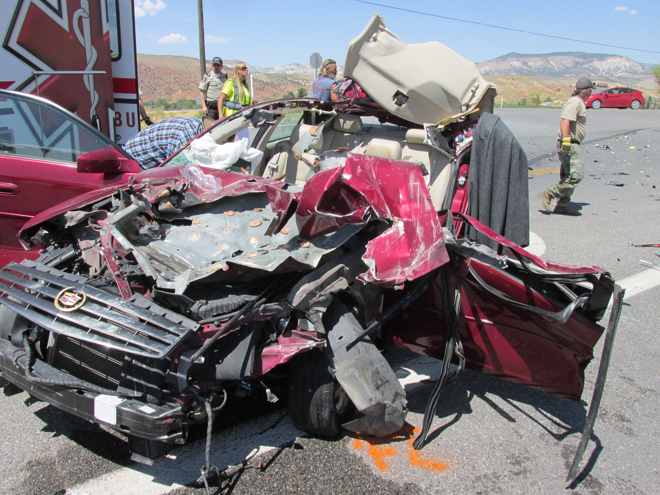 Woman hospitalized after car crash with garbage truck