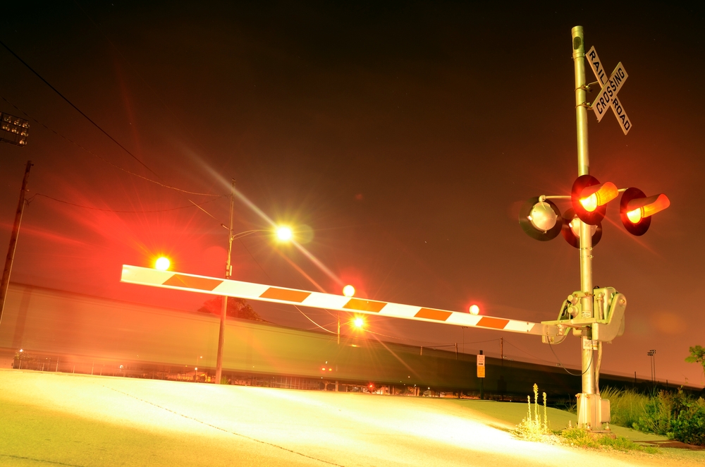 Train hits propane tanker after driver weaves through crossing arms, police say