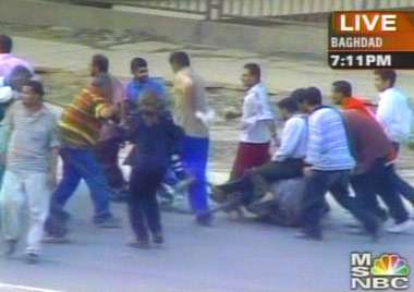 Iraqis Attack Statue of Saddam