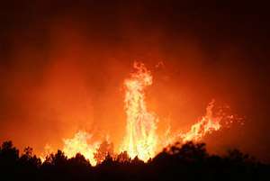 Firefighters Hold Back Flames Near New Harmony