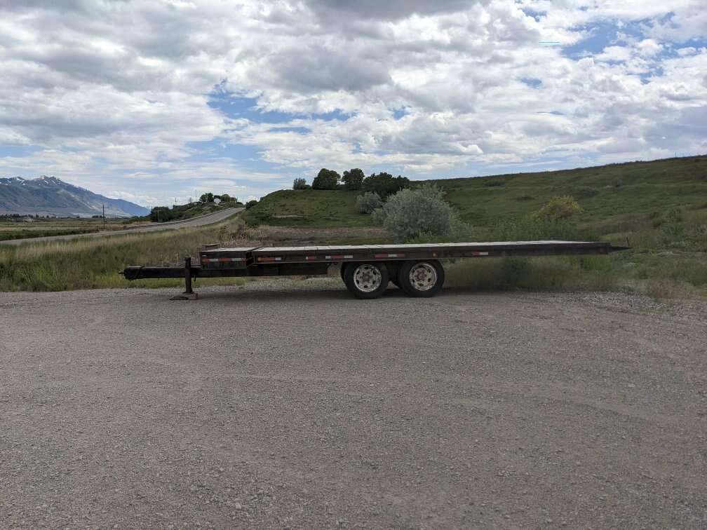 Heavy equipment tilt deck trailer