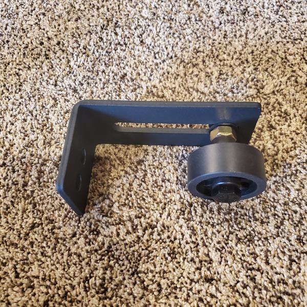 Bottom guide roller for barn doors