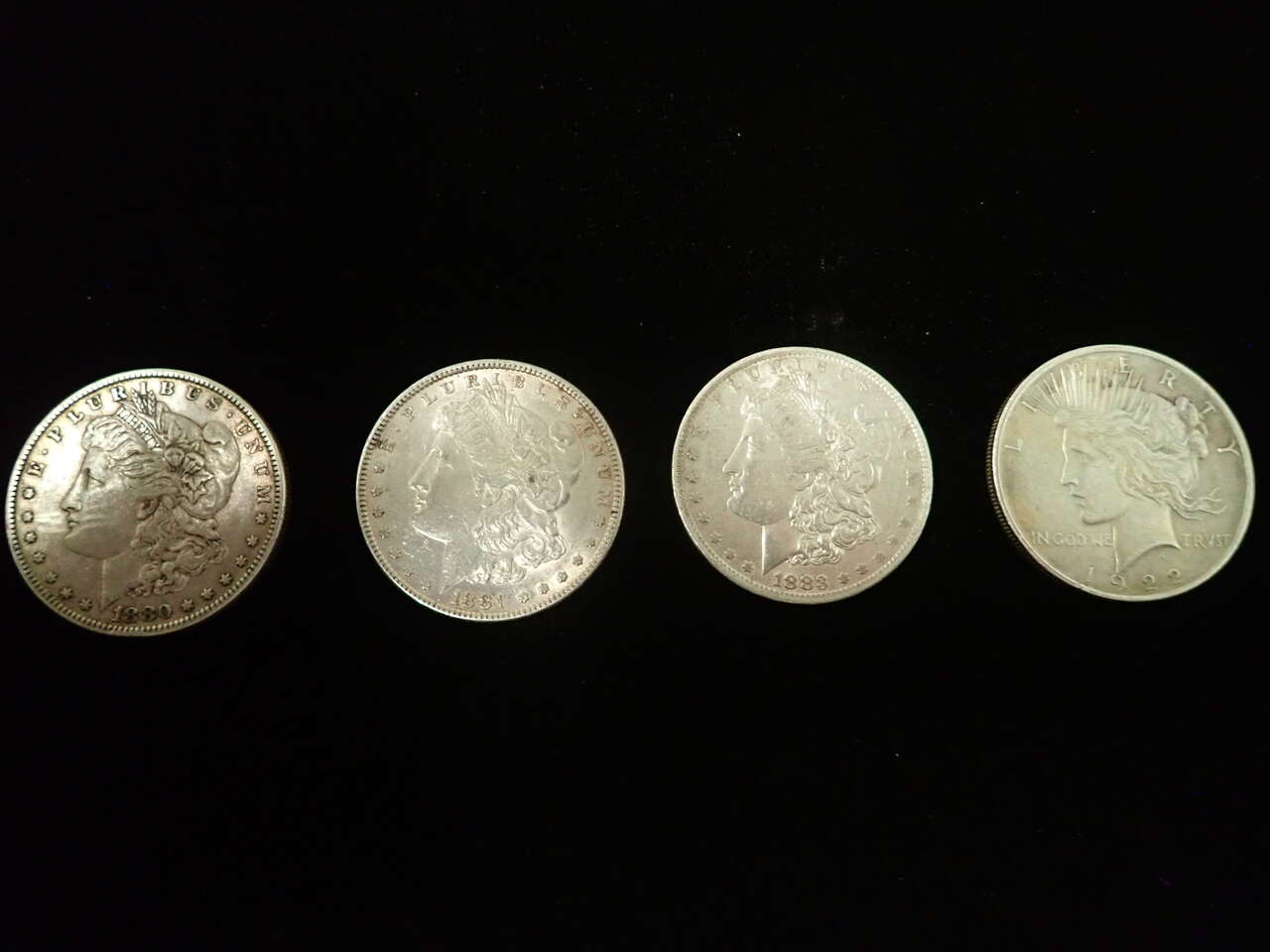 Silver Dollars (4), 3 Morgan  1880, 1881, 1883 and and 1 Liberty 1922 (with misspelled Trvst)