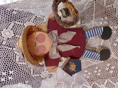 Wooden Raggedy Ann Angel Wall Hanging That Has A Wreath With A Bird In It Holding A Bird House Wearing A Straw Hat