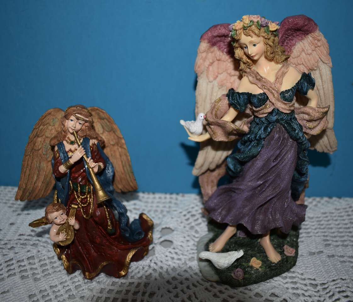 Two Ceramic Angels - One With Doves Another One Playing A Flute With A Baby Angel Also Playing A Musical Instrument