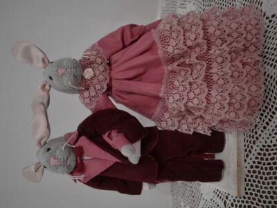 Handmade Bunny Rabbit Dolls All Dressed in Pink And Maroon Formal Wear On A Wooden Stand