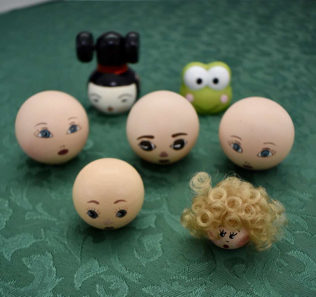 Several Wooden And One Plastic Doll Heads With Painted Faces For Making Dolls Or Crafts