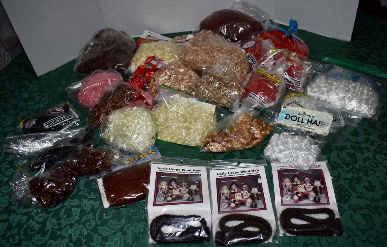 Several Assorted Bags Of Fun Wavy And Curly Doll Hair In Different Sizes, Colors, And Kinds