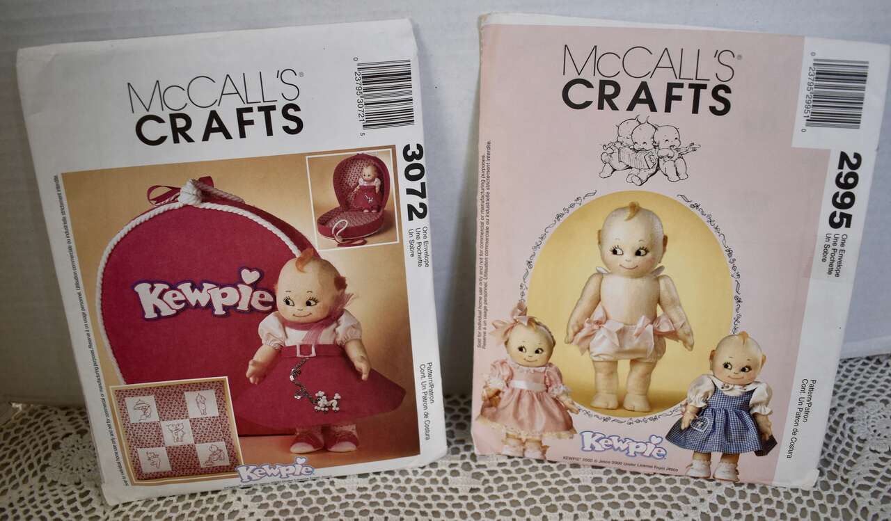Set Of 2  McCalls Crafts Patterns With Kewpie Doll, Clothes, Carrying Case And Wall Hanging Instructions And Patterns To Make.