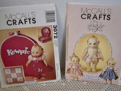Set Of 2 McCalls Crafts Patterns With Kewpie Doll, Clothes, Carrying Case And Wall Hanging Instructions And Patterns To Make.