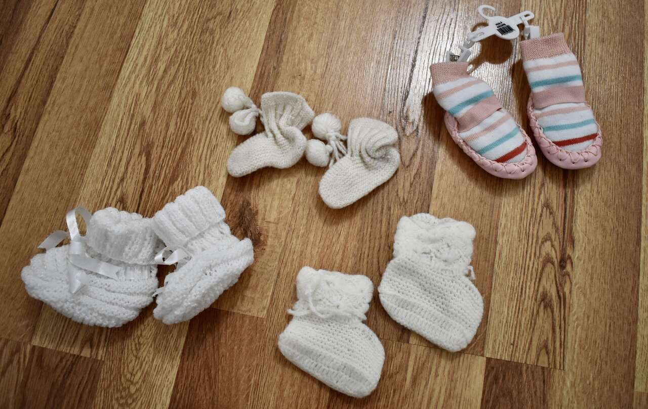 SEVERAL VINTAGE BABY CROCHET AND OTHER BOOTIES OR FOOT WEAR FOR A BABY SOME NEW SOME USED