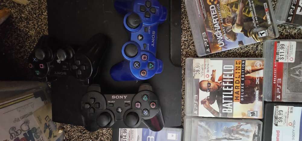 PS3 with controllers and games
