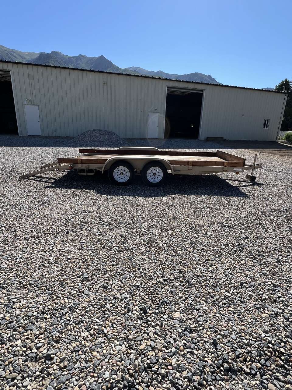 Tan tandem axle dovetail car hauler trailer 16x7 foot 4 inches deck with heavy duty ramps & spare tire & rim