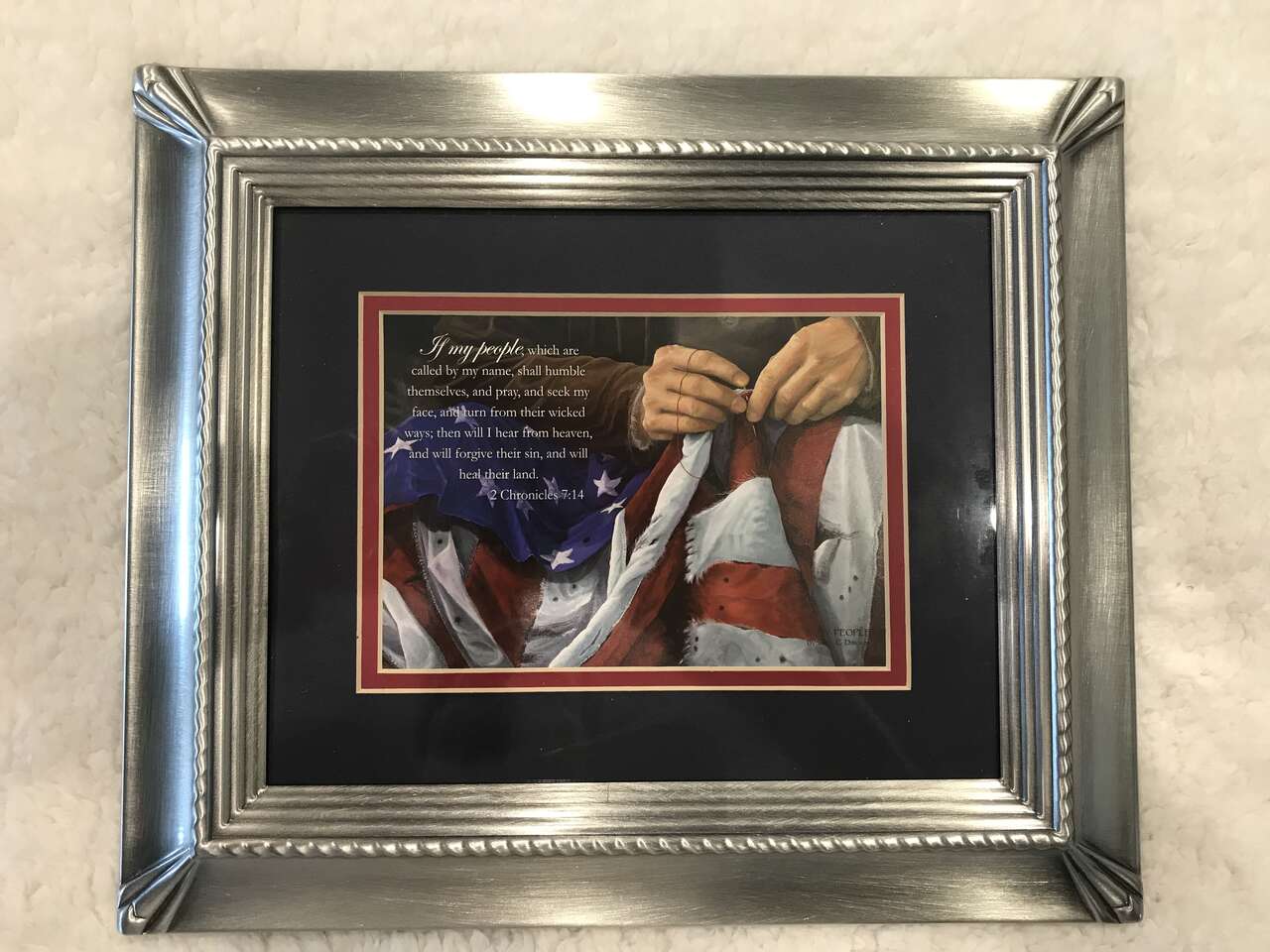 Patriotic picture with praying hands and a flag