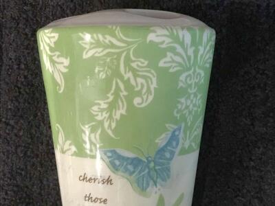 Toothbrush holder with leaves and butterfly designs on it