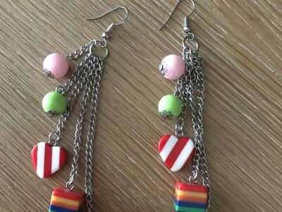Earrings with a strawberry, a rainbow box and a heart on them