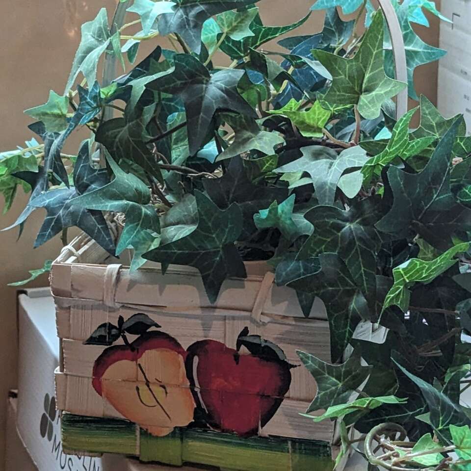 Small white with apples basket.