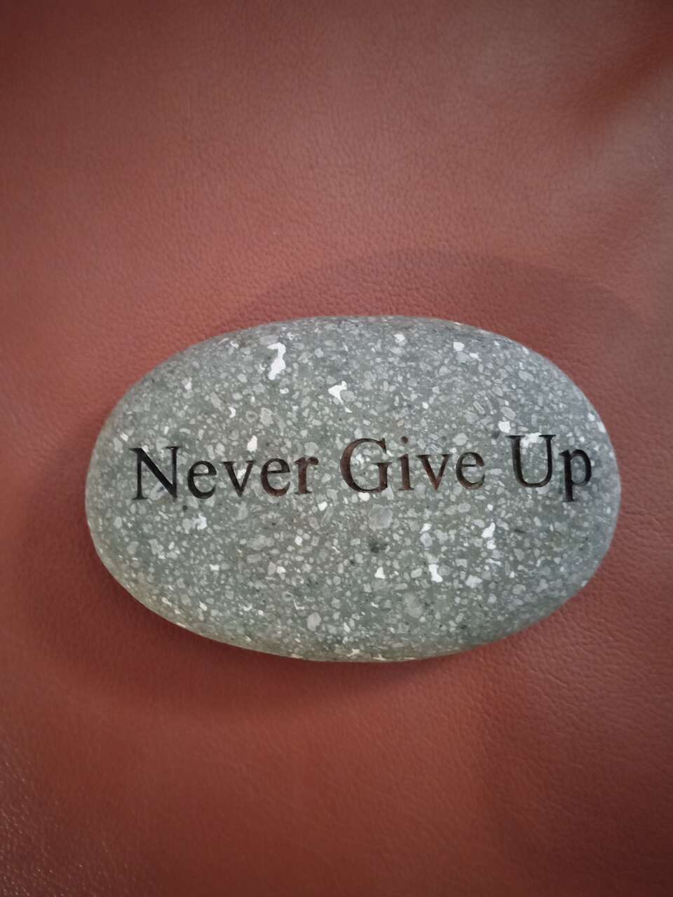 Engraved granite stone rock never give up