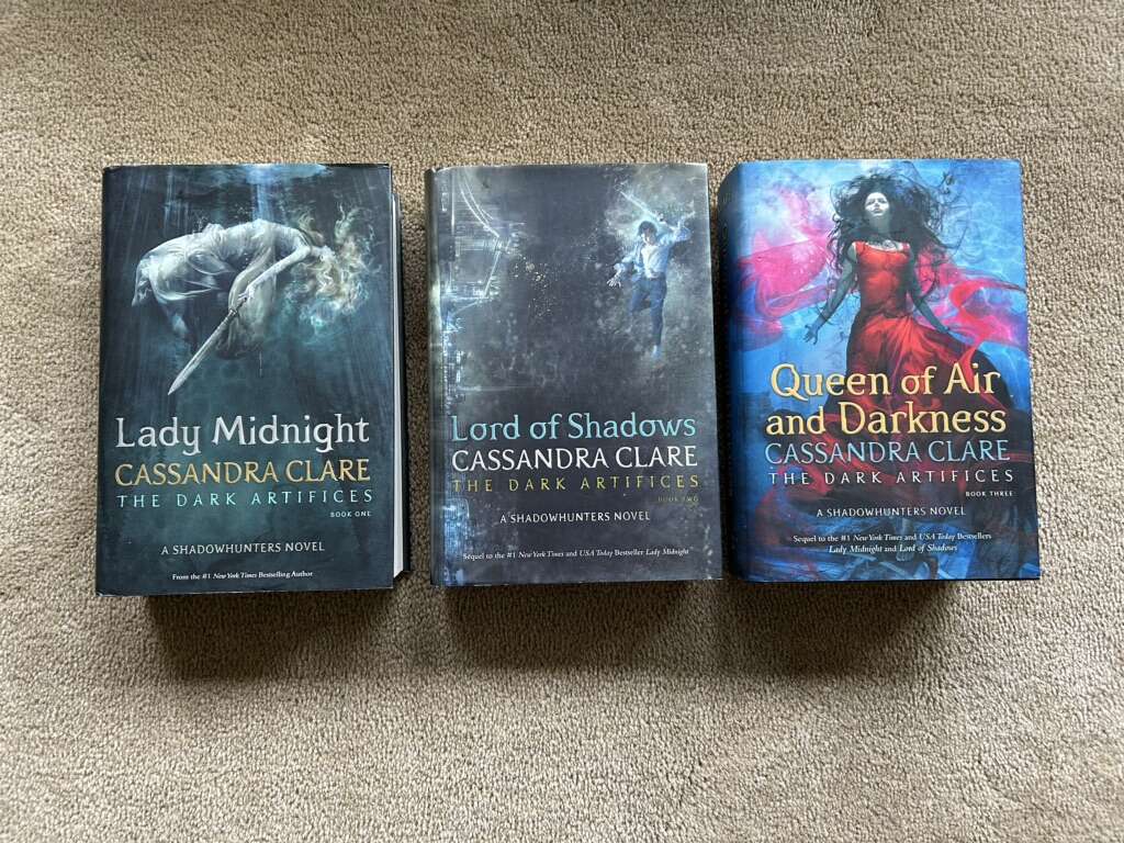 The Dark Artifices Trilogy, by Cassandra Clare (hardcovers)—ONE SIGNED