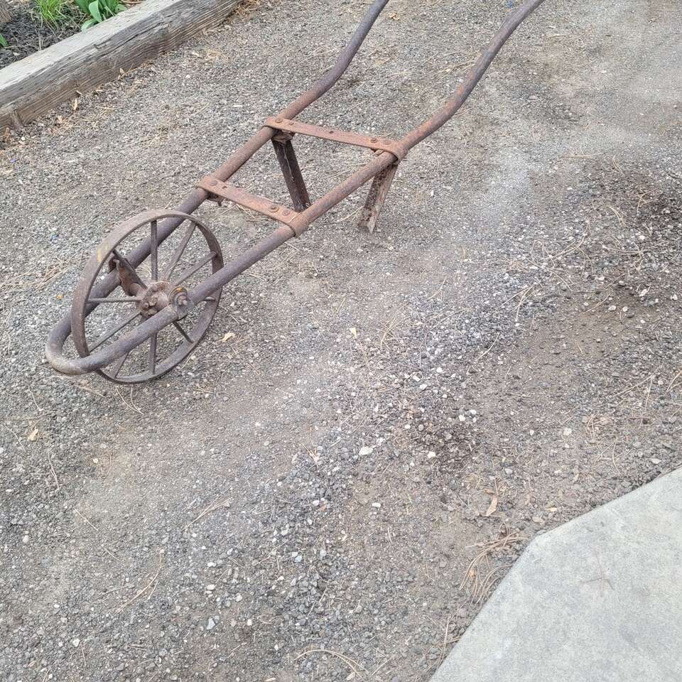steel old wheelbarrow frame and wheel /Yard art