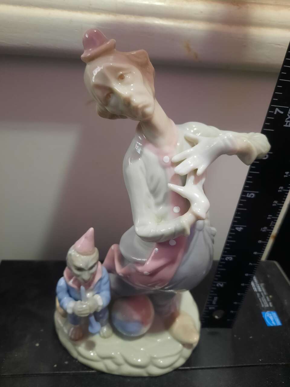 sad clown with a monkey and ball porcelain figure