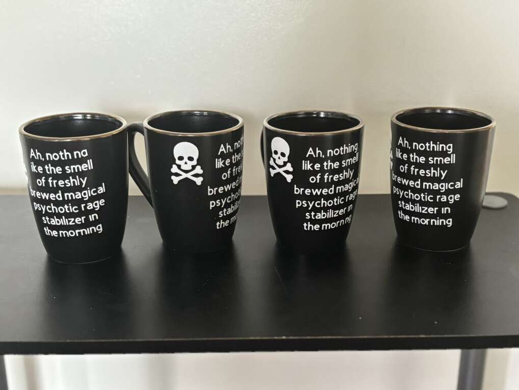 4 Skulls Halloween 12oz Black Mug. Nothing