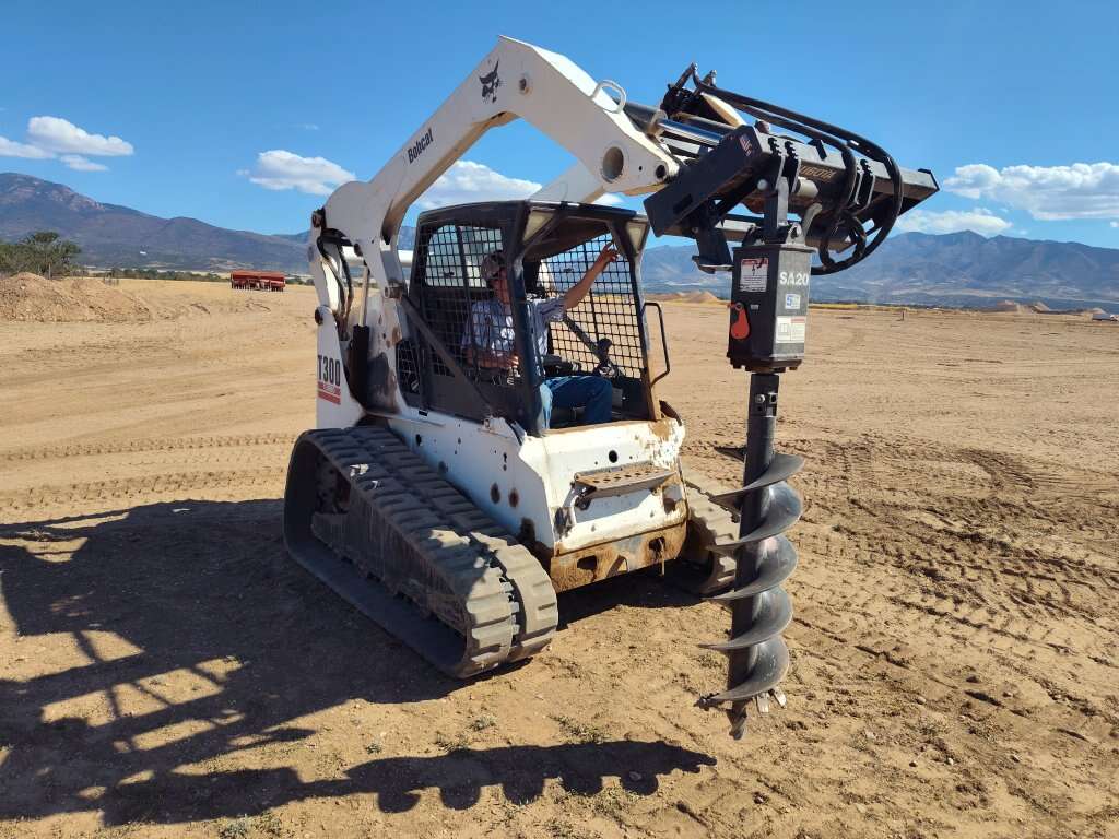 skid steer and pipe fence work