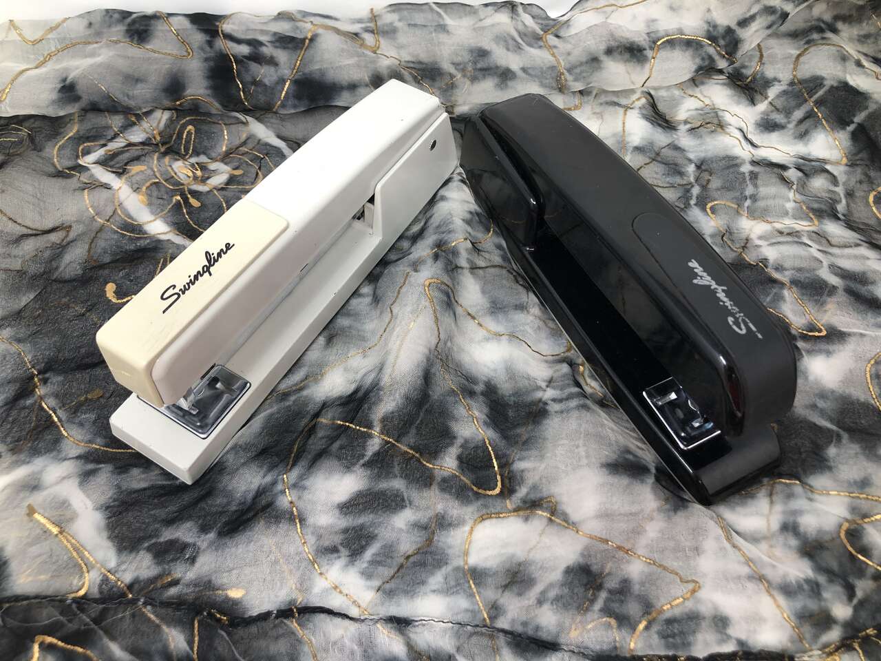 Black and tan Swingline Staplers