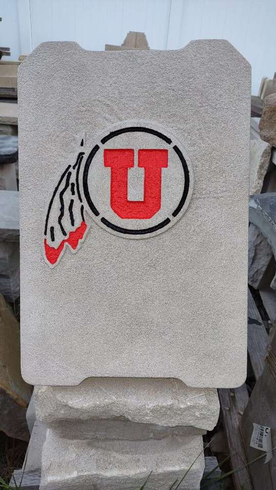 Utes and BYU logo on stone