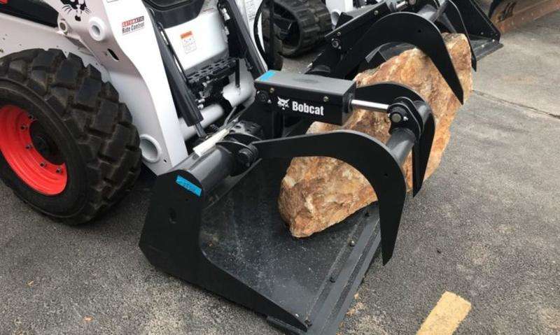 Bobcat Skid steer with grapple bucket. Great for picking up scrap, debris, trees, etc
