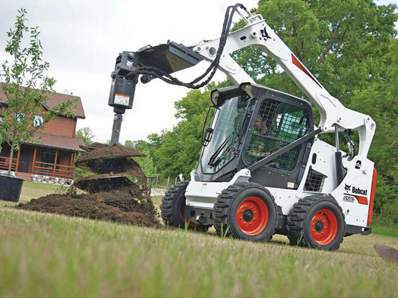Bobcat Skid Steer with auger attachment. Great for installing fences