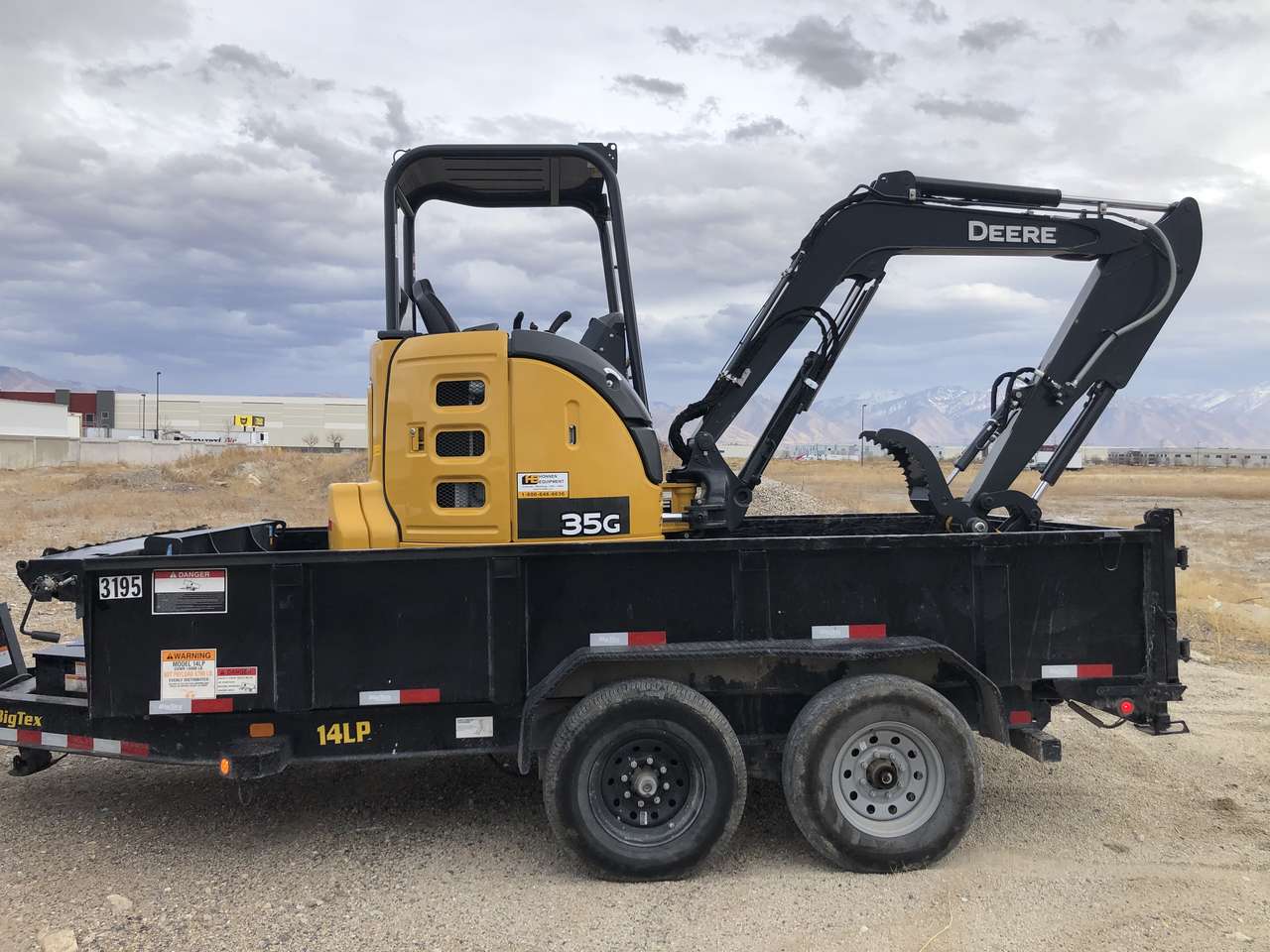 Deere 35G mini excavator and dump trailer combo. 8300 lb mini-ex with cab and thumb