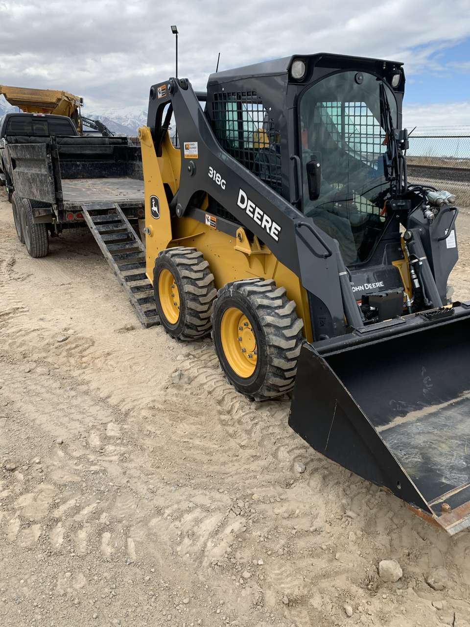 318G Skid steer and dump trailer combo package. Easy to load and transport