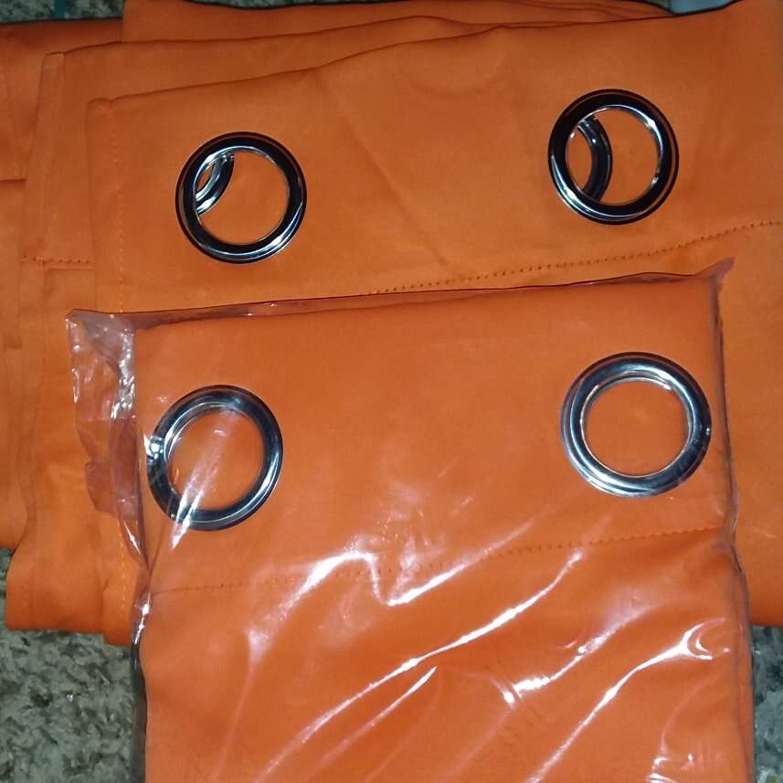2 ORANGE BLACK OUT CURTAINS.. 84 INCHES