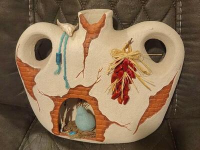 Southwestern style pottery vase art, with cut out for a bird scenery inside and a light