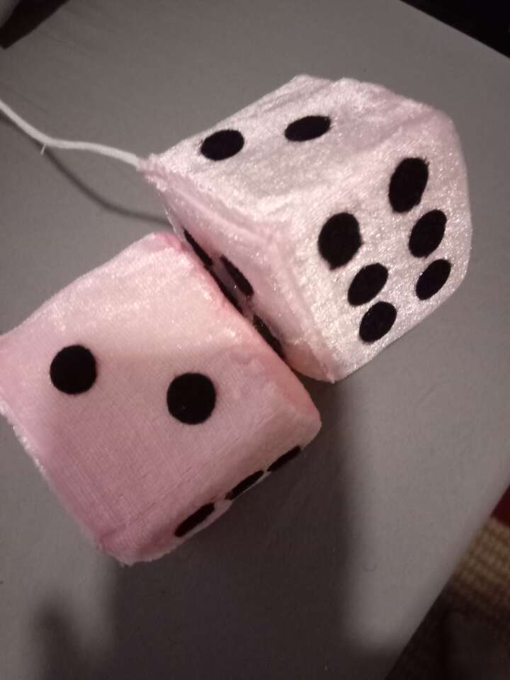 Brand new light pink rear view fuzzy dice with black colored dots