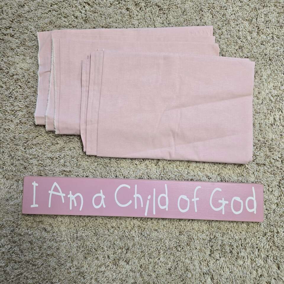 Pink curtains/fabric and sign