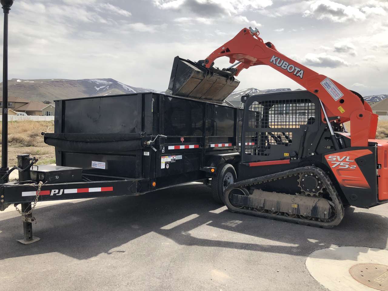 A/C Cab. Kubota track skid steer and dump trailer combo for RENT.