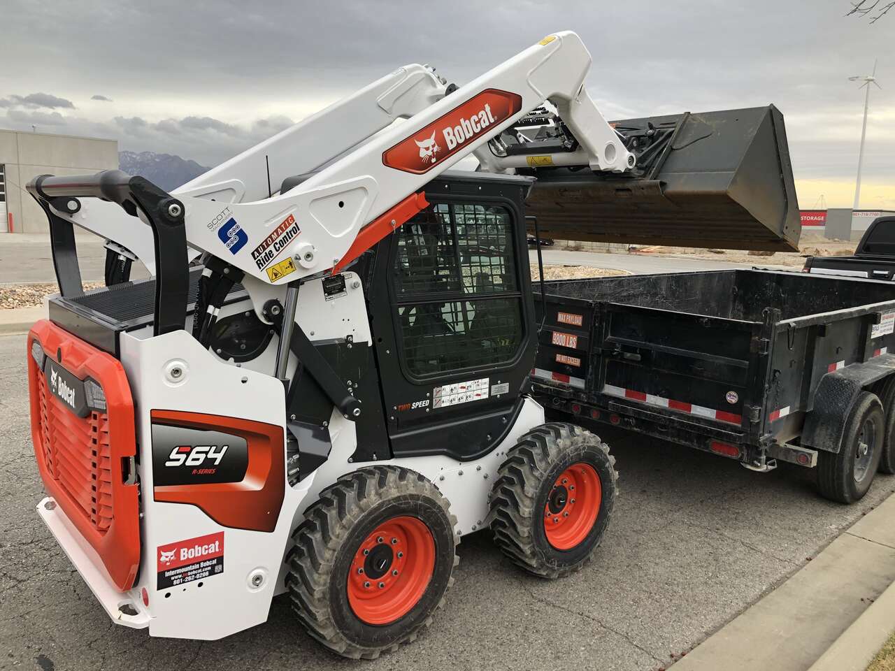 Bobcat skid steer and dump trailer combo for rent.