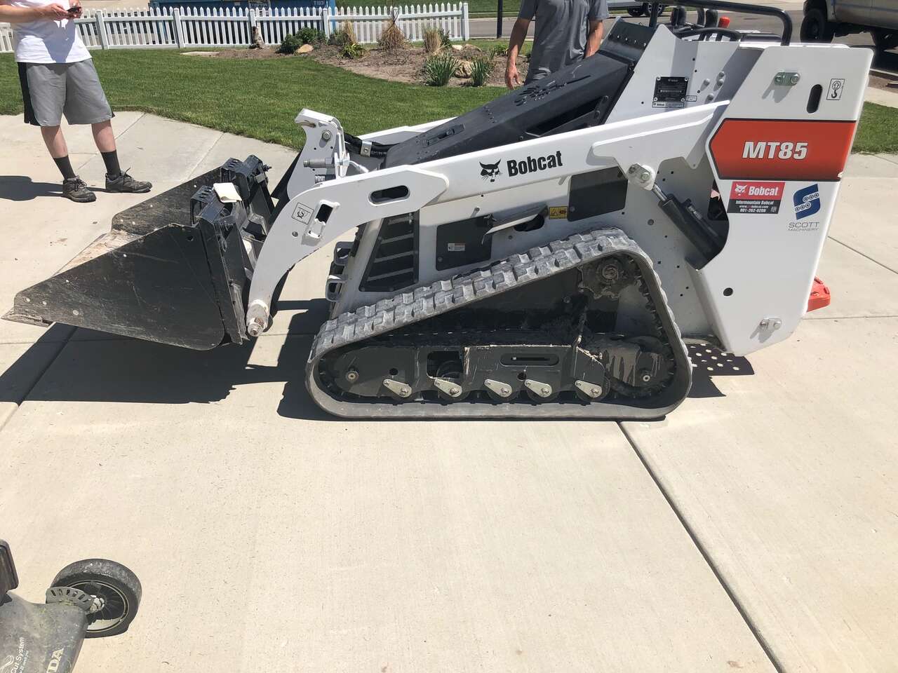 Mini stand-on skid steer bobcat for rent. Only 41 inches wide, fits through tight gates