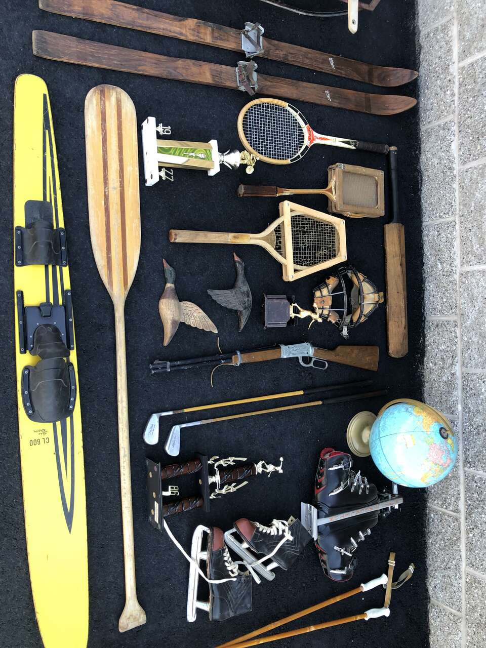 Antique cabin decor, wall hangings, baseball, skis, tennis rackets, ice skates, sleds, golf clubs, trophies, fishing, vintage