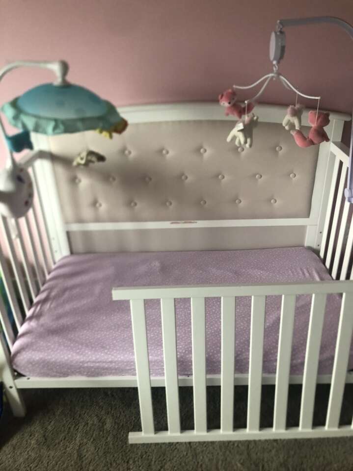 4-in-1 pink and white upholstered crib