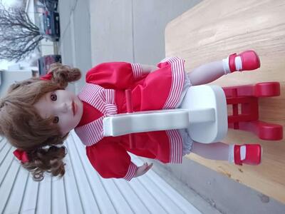 Porcelain Doll with Rocking Horse.