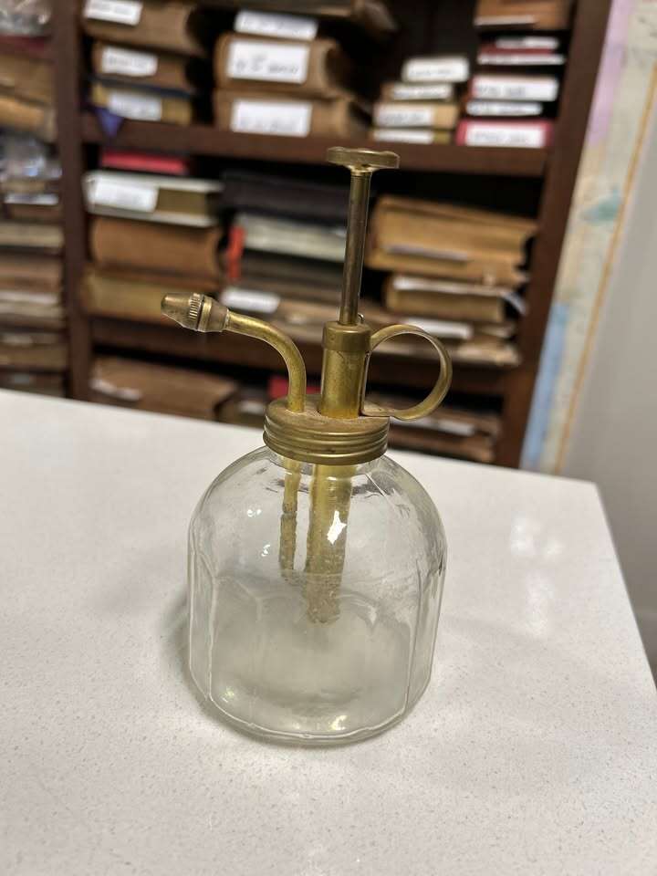 Glass perfume bottle with possible brass head