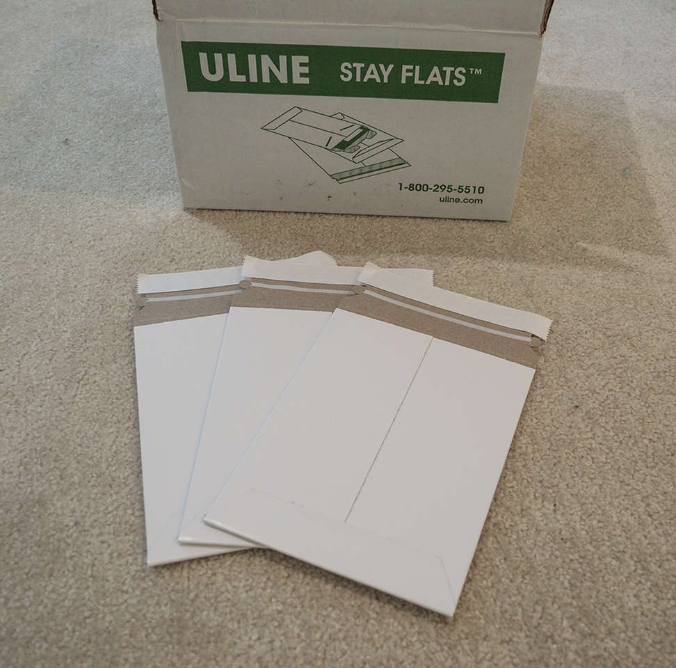 White 6 x 8 inch Stay-Flat Self-Sealing Rigid Uline Mailers - 100