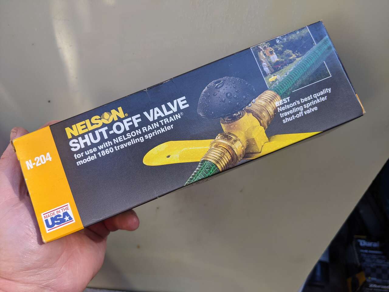 Traveling lawn tractor sprinkler bump stop water shut-off hose