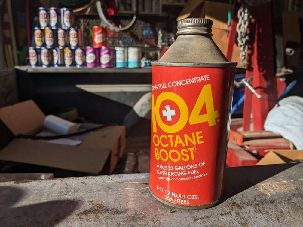 Vintage oil cans 104 + octane boost gas pump sign