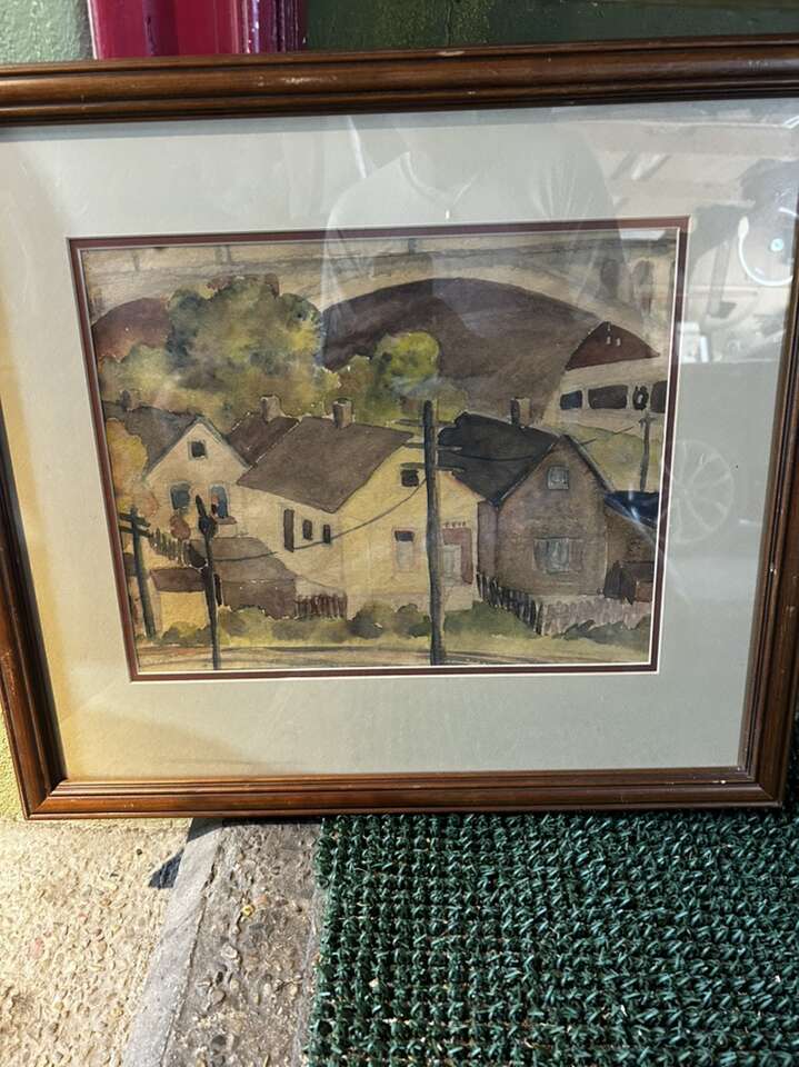 Frame watercolor painting of houses.